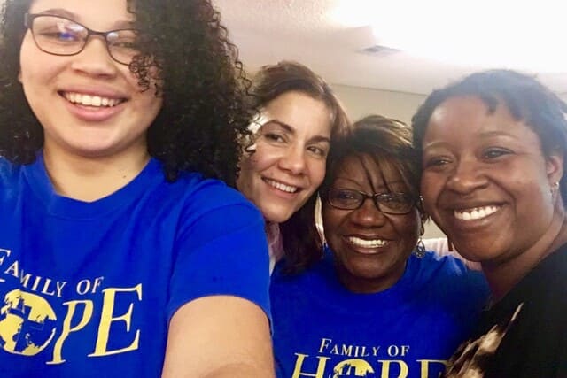 four volunteers smiling in fellowship