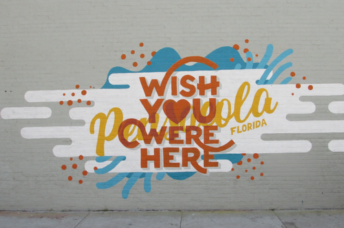 Wish You Were Here graphic on a concrete wall